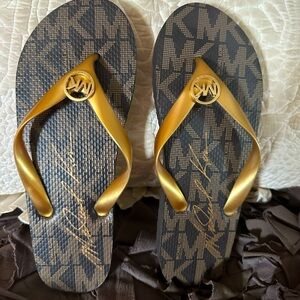 Michael Kors Flip Flops. Size 9. NEVER WORN.
